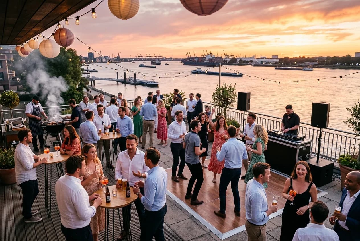 Corporate summer party on an Elbe-side terrace in Hamburg with sunset and team celebrating